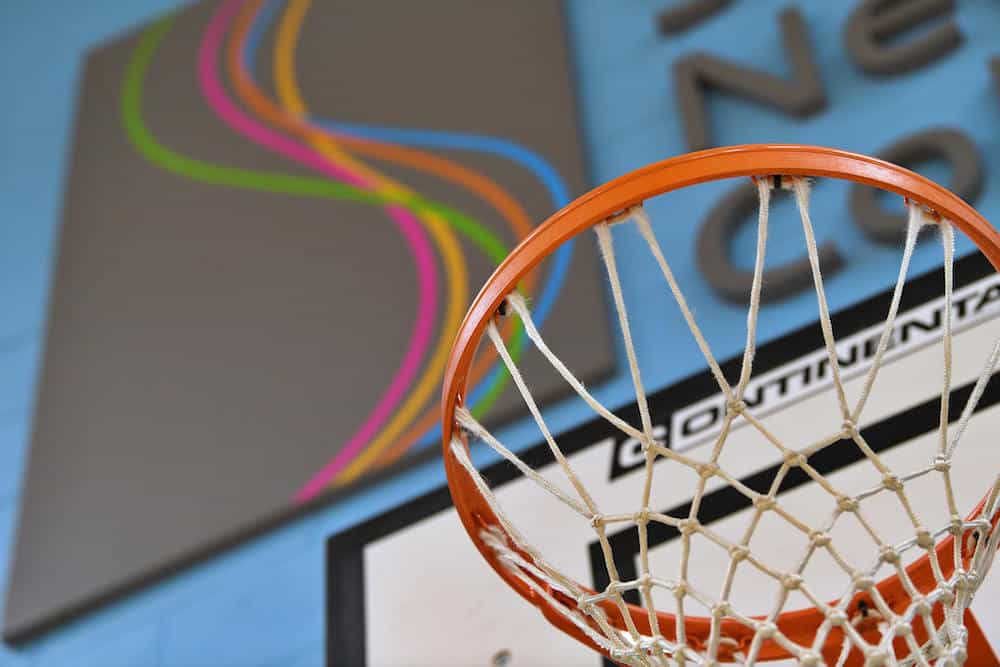 A closeup photo of a basketball net in the Suffolk New College sports centre.