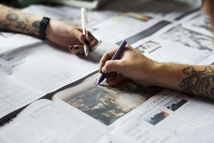 Close up of learner annotating newspaper