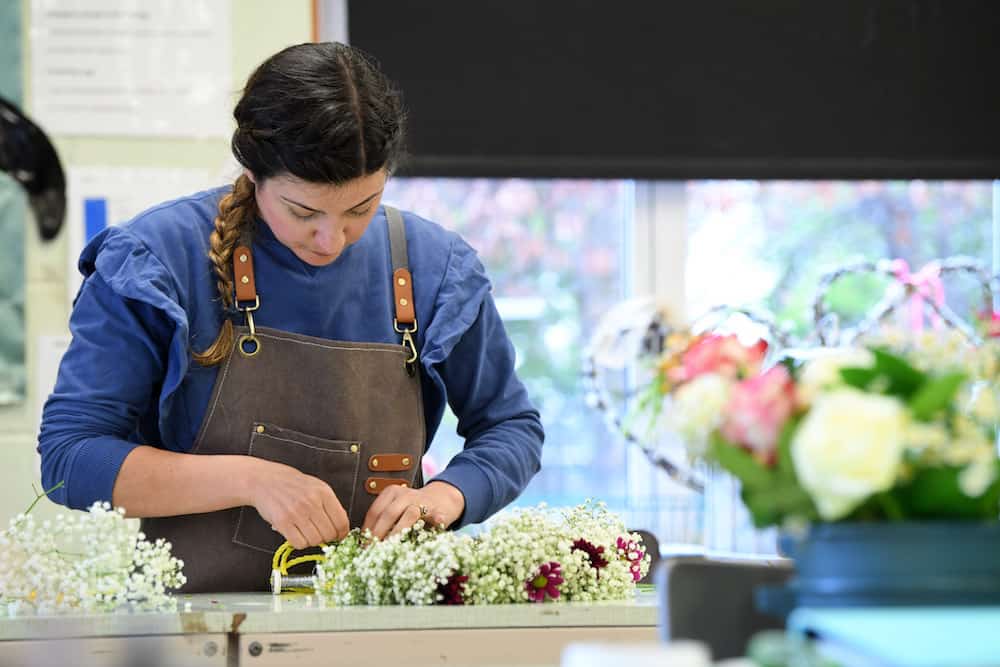 An adult learner in a floristry class
