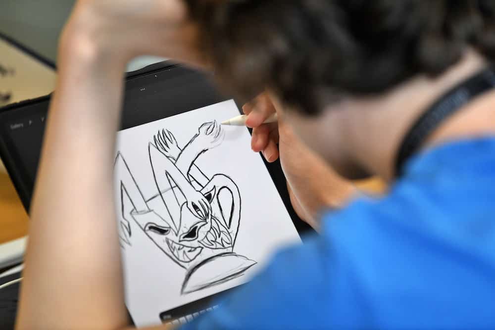 Game Arts learner illustrating on an iPad