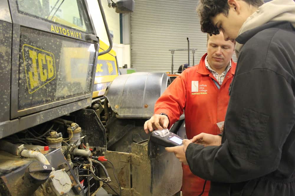 Tutor demonstrating skill in the workshop