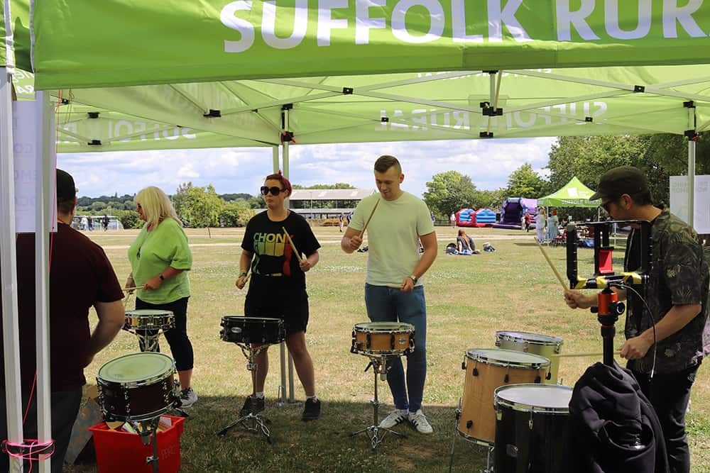 Staff attending a drumming workshop at a wellbeing day