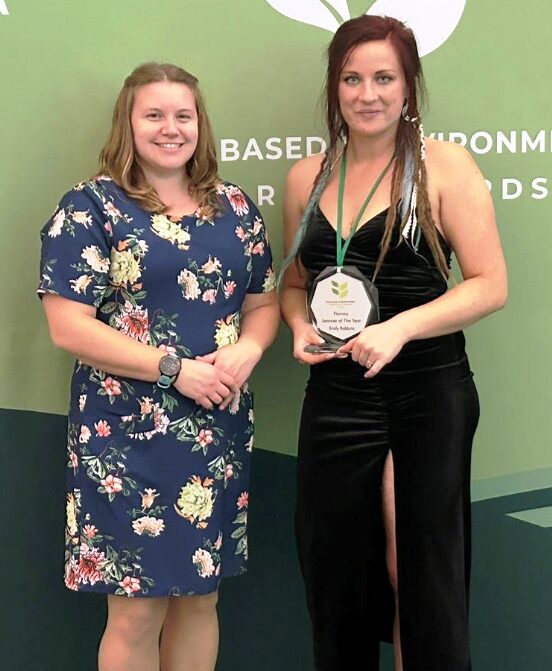 Alison Jeffries and Emily Robbins posing for a photo with the award