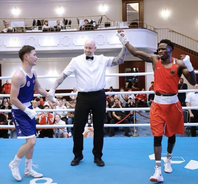 Simon Mullan raising winners hand during world cup boxing fight