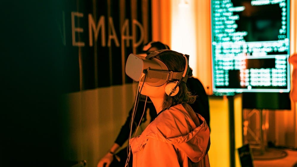 Two people wearing VR goggles in a technology suite.