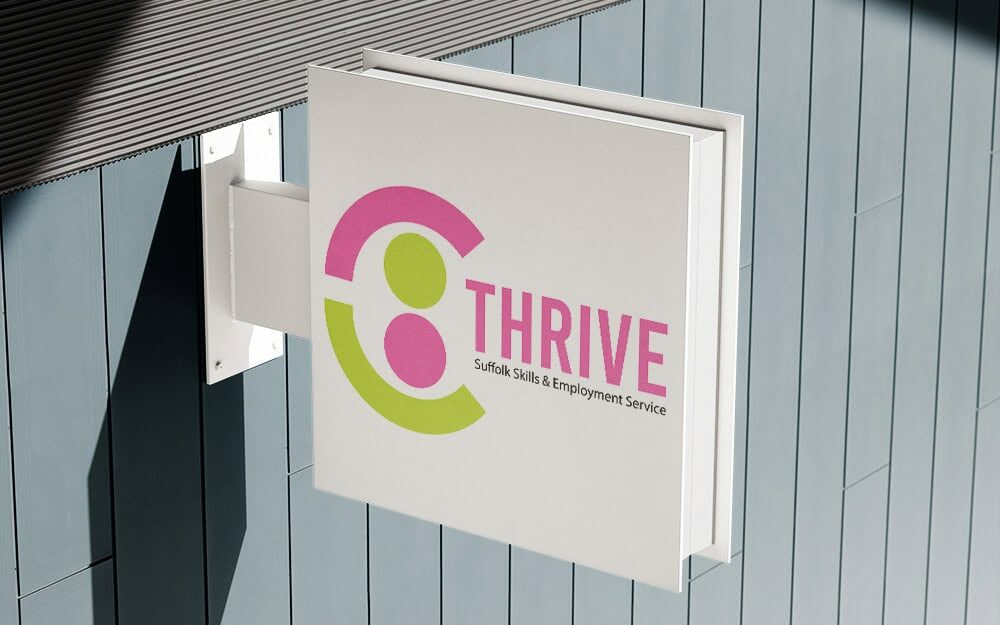 Thrive logo displayed on a sign outside a building.